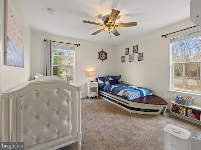 carpeted bedroom featuring ceiling fan and baseboards