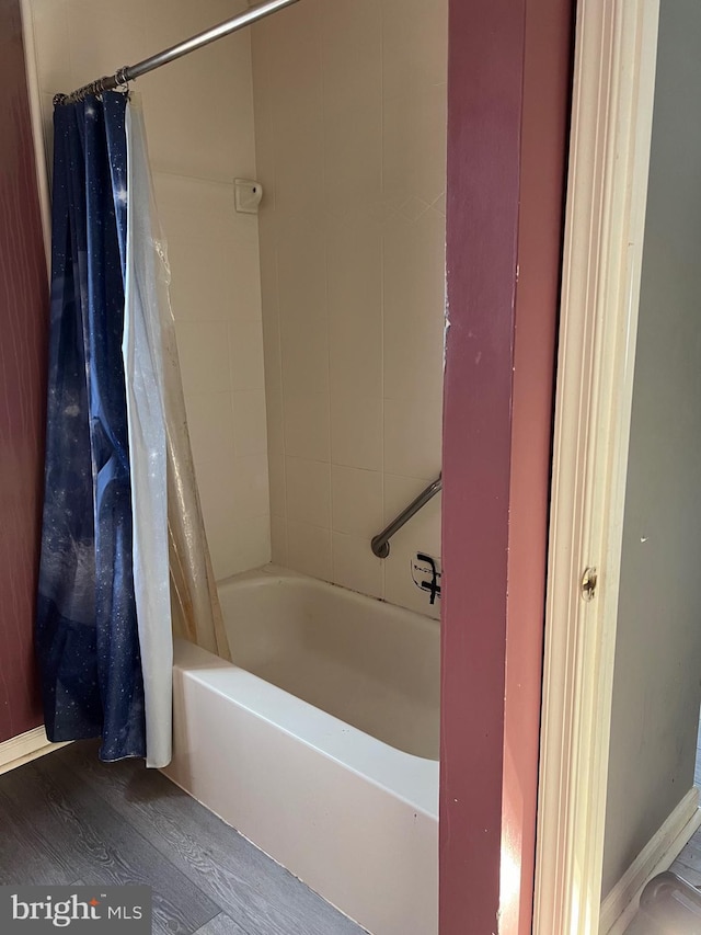 bathroom featuring shower / tub combo and wood finished floors