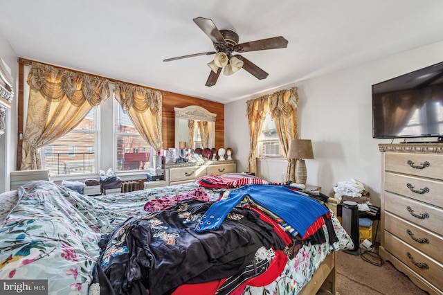 bedroom with ceiling fan, cooling unit, and carpet flooring