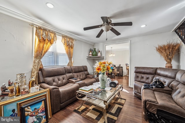 living area featuring ceiling fan with notable chandelier, dark wood-type flooring, and recessed lighting