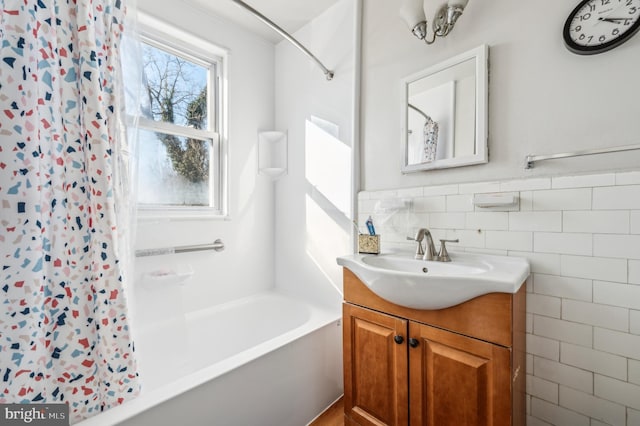 full bathroom with shower / bathtub combination with curtain, wainscoting, tile walls, and vanity