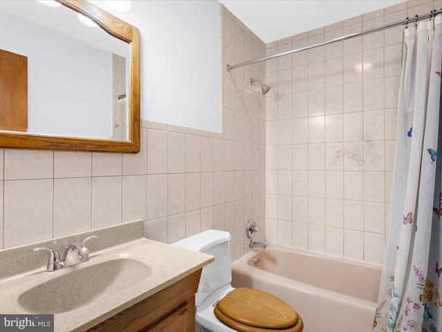 bathroom featuring toilet, vanity, tile walls, and shower / tub combo with curtain