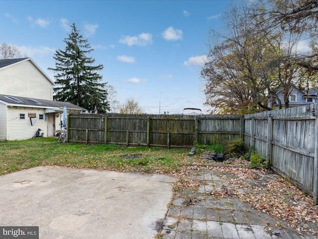 view of yard with a patio area and a fenced backyard