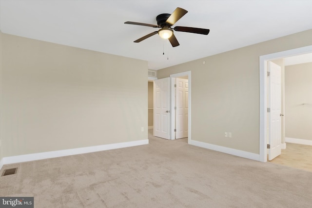 unfurnished bedroom featuring baseboards, visible vents, a walk in closet, and carpet flooring