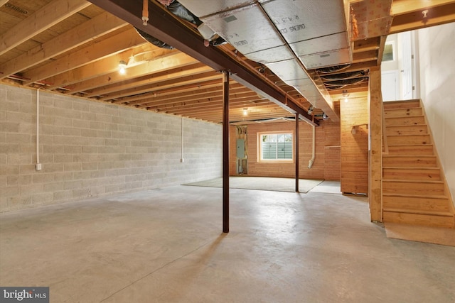 basement with electric panel and stairway