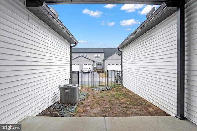 view of yard with a residential view, central AC, and fence