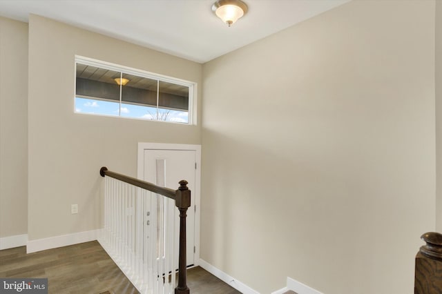 stairway featuring baseboards and wood finished floors