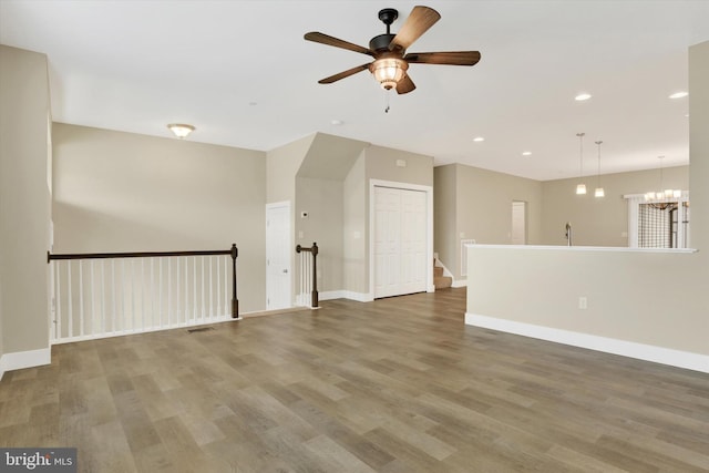 spare room featuring recessed lighting, wood finished floors, visible vents, and baseboards