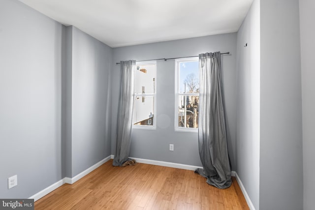 empty room with wood finished floors and baseboards