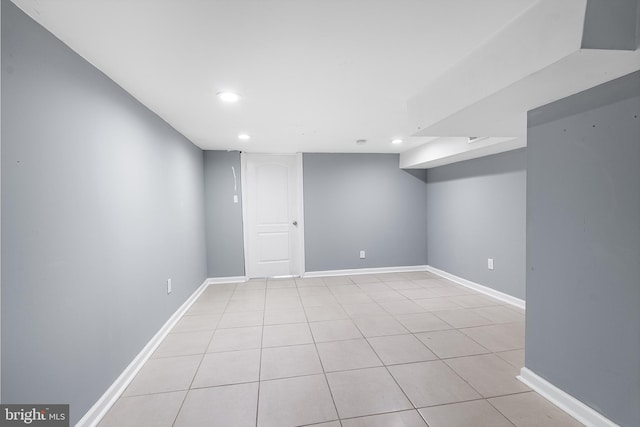 finished basement with light tile patterned floors, baseboards, and recessed lighting