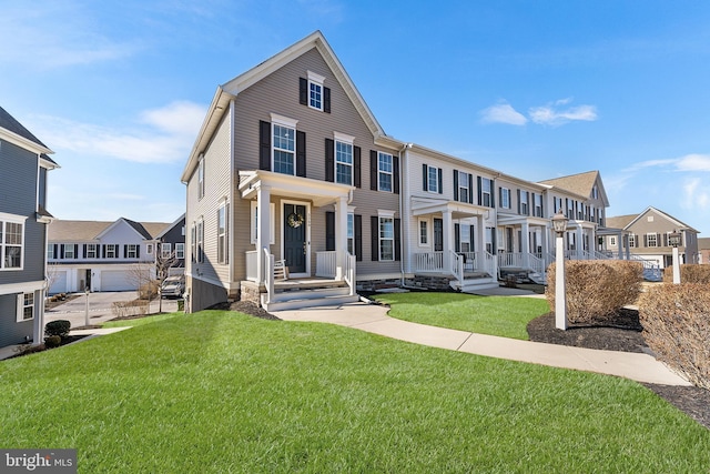 townhome / multi-family property featuring a front yard and a residential view