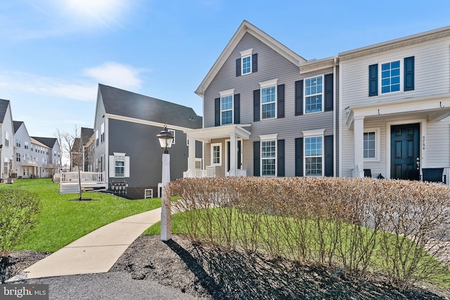 view of front of home featuring a residential view and a front yard