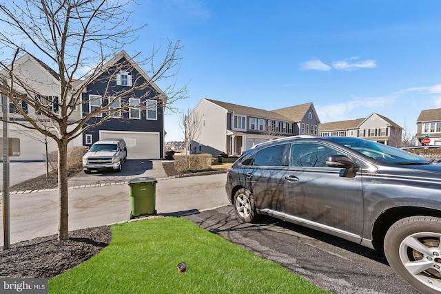 view of yard featuring a garage and a residential view