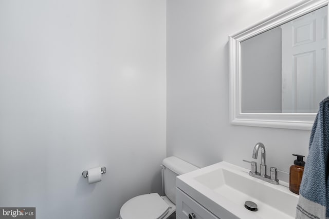 bathroom with toilet and vanity