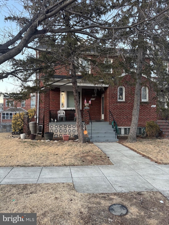 view of front of property with a porch and brick siding