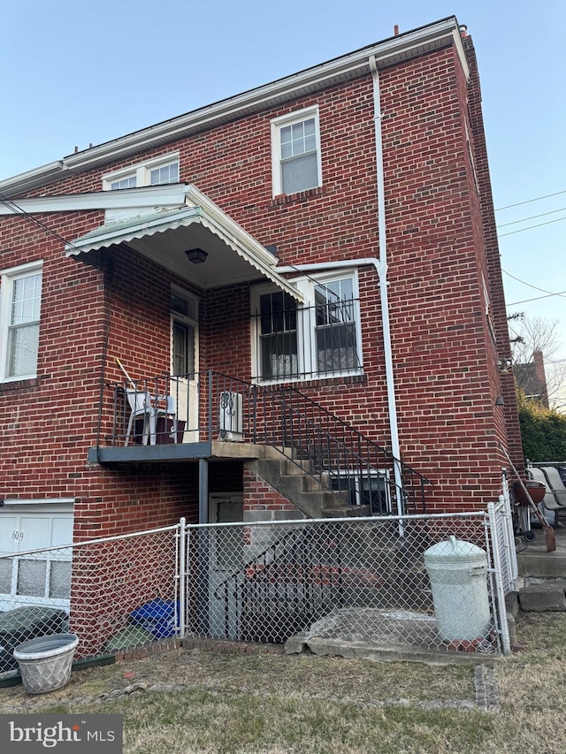 view of front of property with brick siding and fence