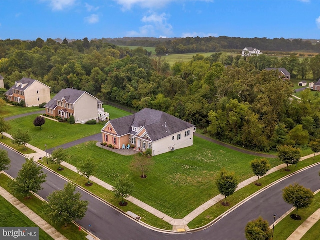 bird's eye view featuring a wooded view