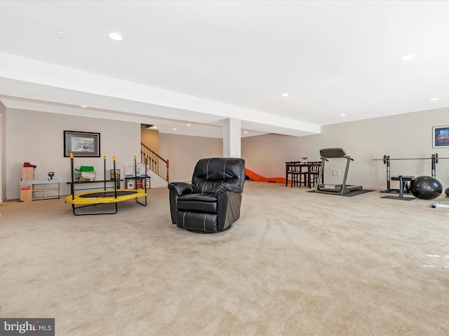 sitting room featuring stairway, recessed lighting, and light colored carpet