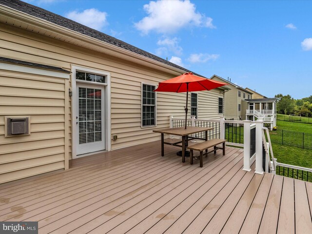 wooden terrace featuring outdoor dining area and fence