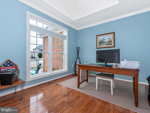 office area featuring ornamental molding, hardwood / wood-style floors, visible vents, and baseboards