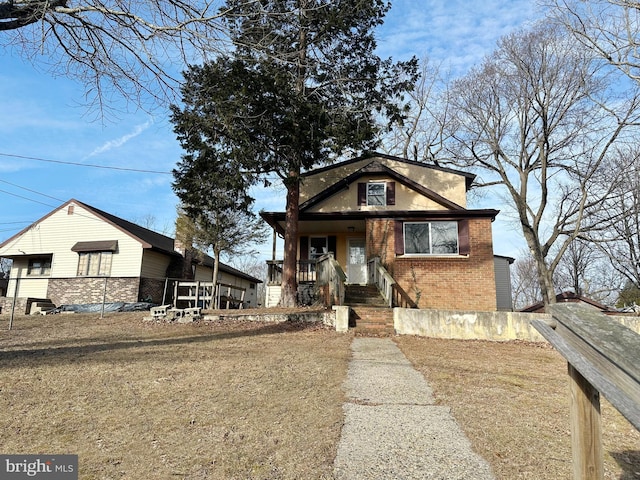 view of front facade featuring a front lawn and brick siding