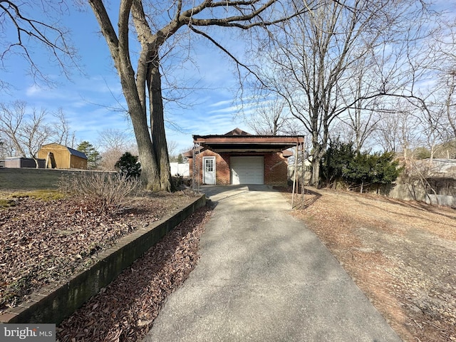 exterior space featuring concrete driveway and brick siding