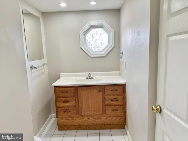 bathroom with recessed lighting, baseboards, and vanity