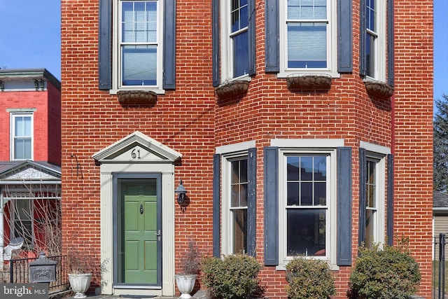 property entrance featuring brick siding