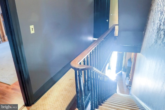 stairway with wood finished floors