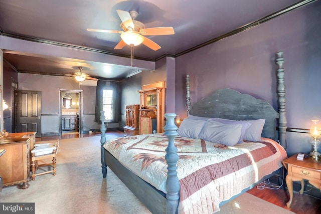 bedroom with crown molding and wood finished floors