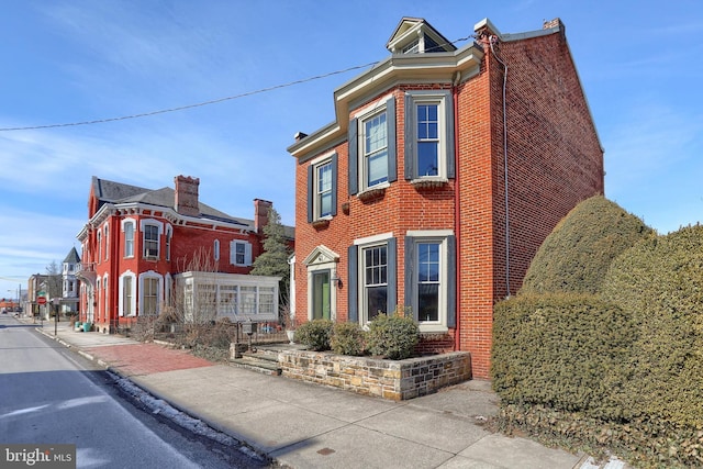 view of side of property featuring brick siding