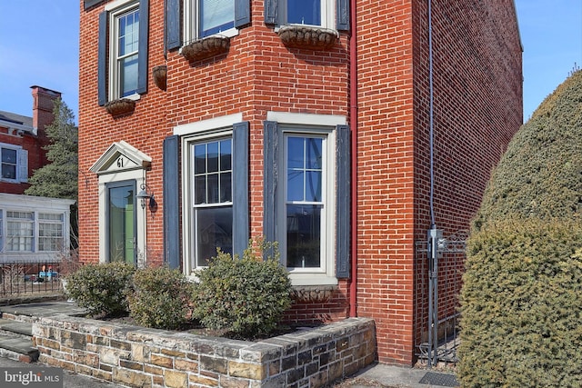 view of exterior entry with brick siding