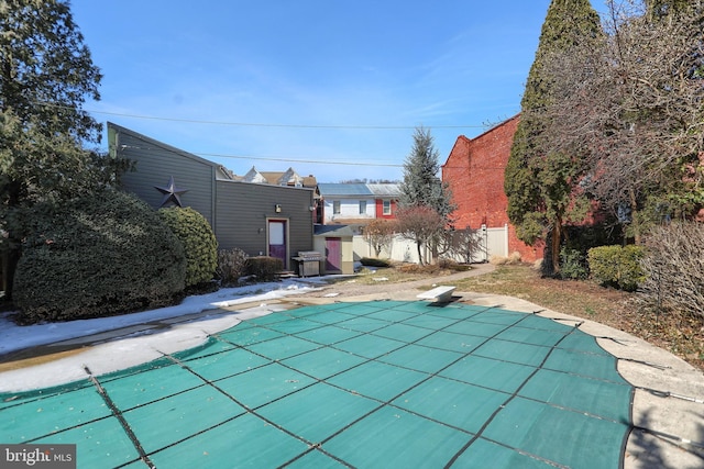 view of pool with grilling area, a diving board, and a fenced in pool