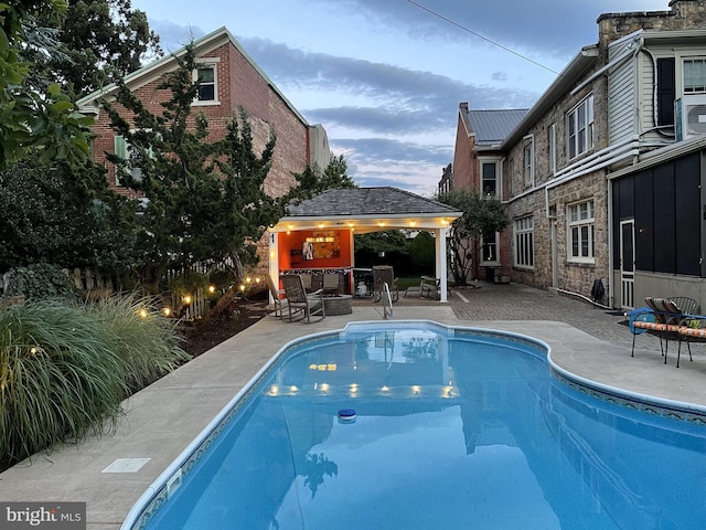 outdoor pool with a patio area and a gazebo