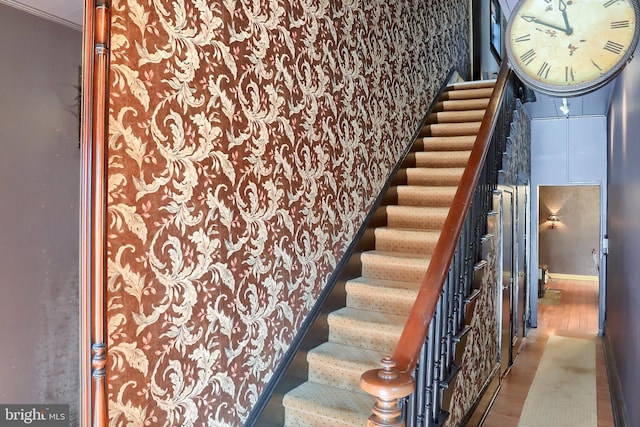 stairs featuring baseboards and wood finished floors