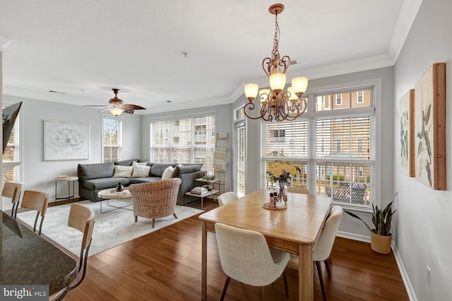 dining room featuring baseboards, wood finished floors, and crown molding