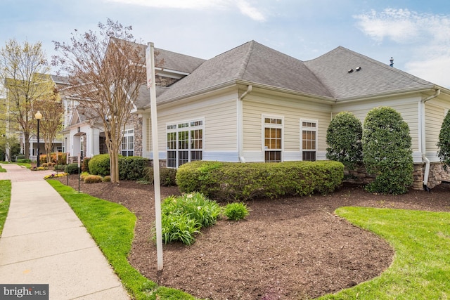 view of property exterior featuring a shingled roof