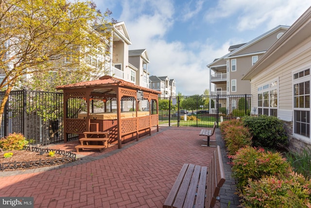 view of home's community with fence and a gazebo