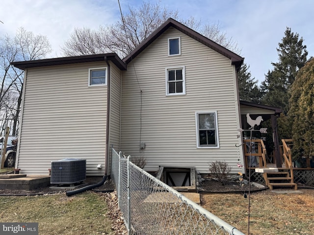 back of house with fence and central air condition unit