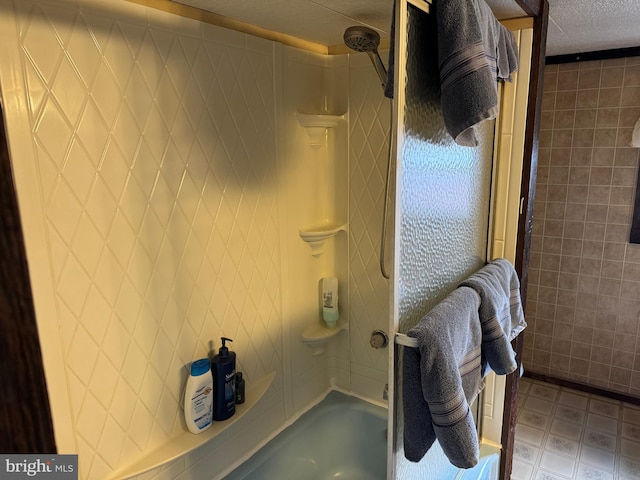 full bathroom featuring bathtub / shower combination, tile walls, a textured ceiling, and tile patterned floors