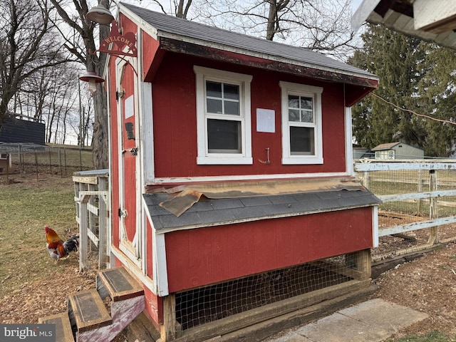 view of poultry coop featuring fence