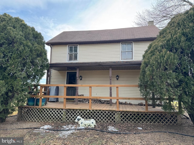 back of property featuring a wooden deck