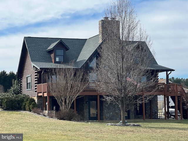 view of front of home featuring log siding, stone siding, a front lawn, and stairway