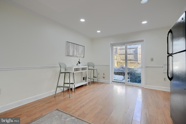 office area with light wood-style floors, baseboards, and recessed lighting