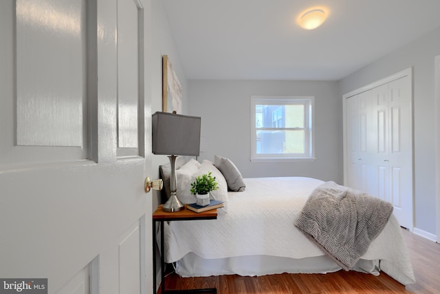 bedroom with a closet and wood finished floors