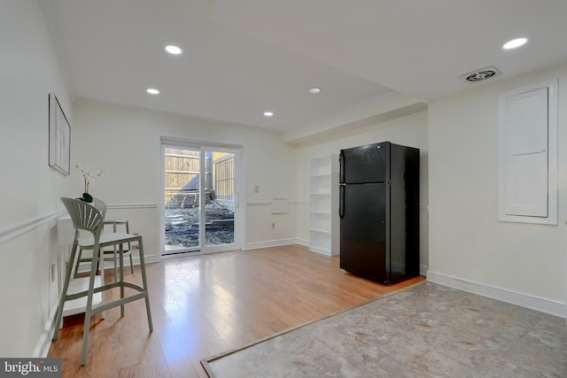 kitchen with recessed lighting, visible vents, baseboards, freestanding refrigerator, and light wood finished floors