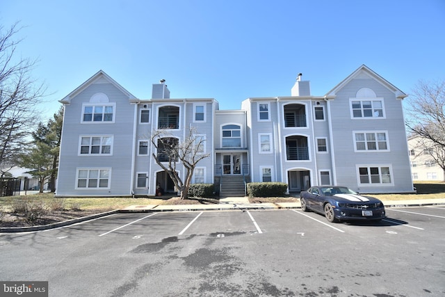 view of building exterior with uncovered parking