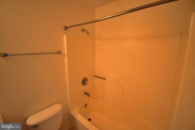 bathroom with shower / bathing tub combination and toilet