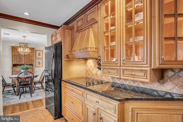 kitchen with custom range hood, backsplash, black appliances, glass insert cabinets, and crown molding