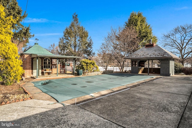 view of swimming pool with a fenced in pool, fence, and a gazebo